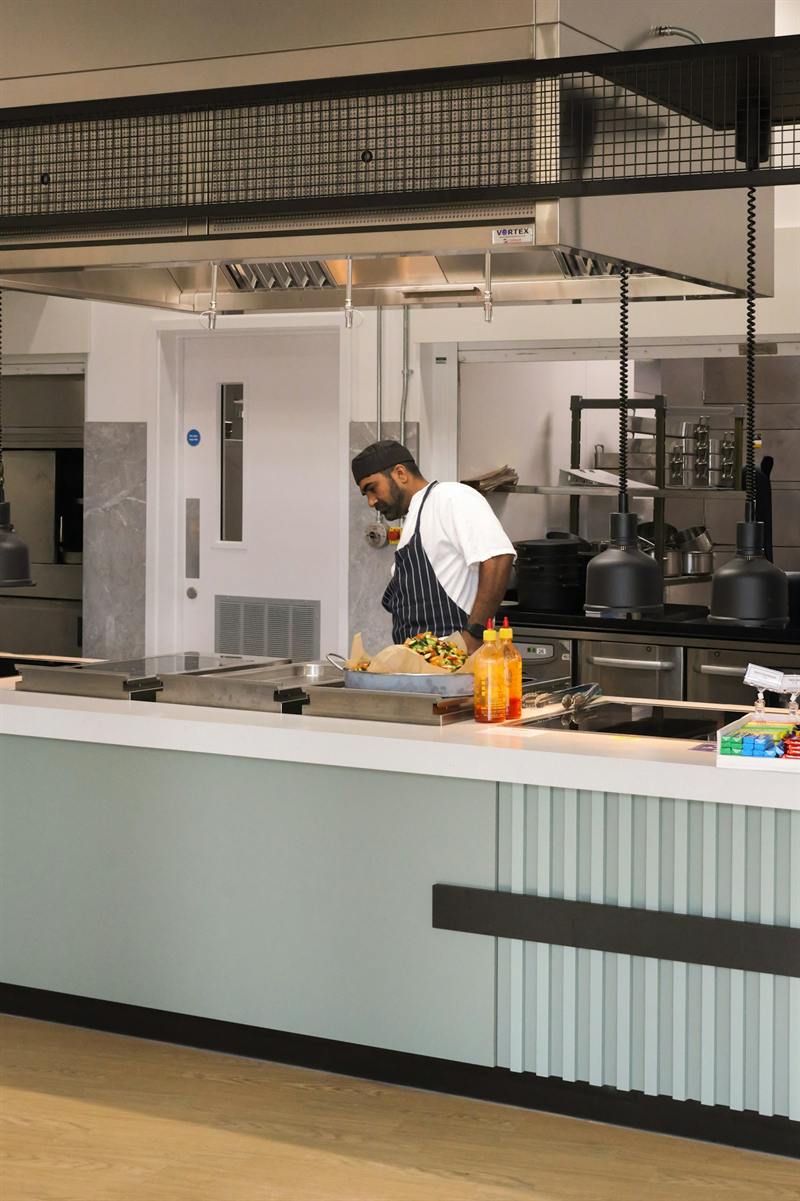 A chef preparing food in a professional kitchen